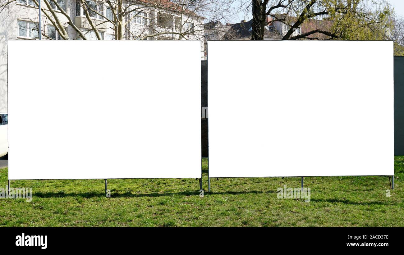 Zwei leere Leere Anzeigentafeln nebeneinander auf städtischen Grünflächen am Straßenrand Stockfoto