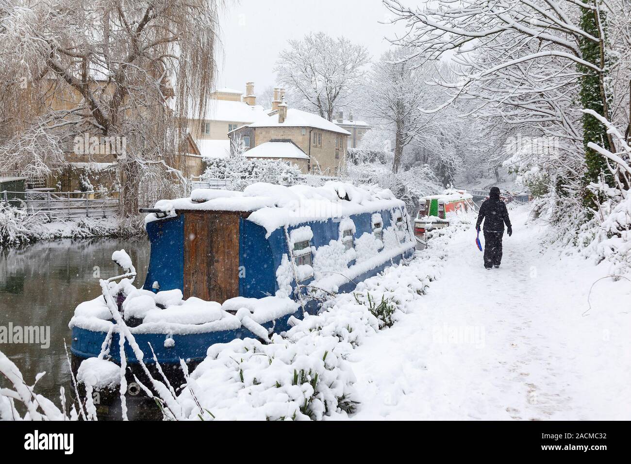 Frau wandern in schweren Schnee auf dem Kennet und Avon Leinpfad in Bath, England, UK. Stockfoto