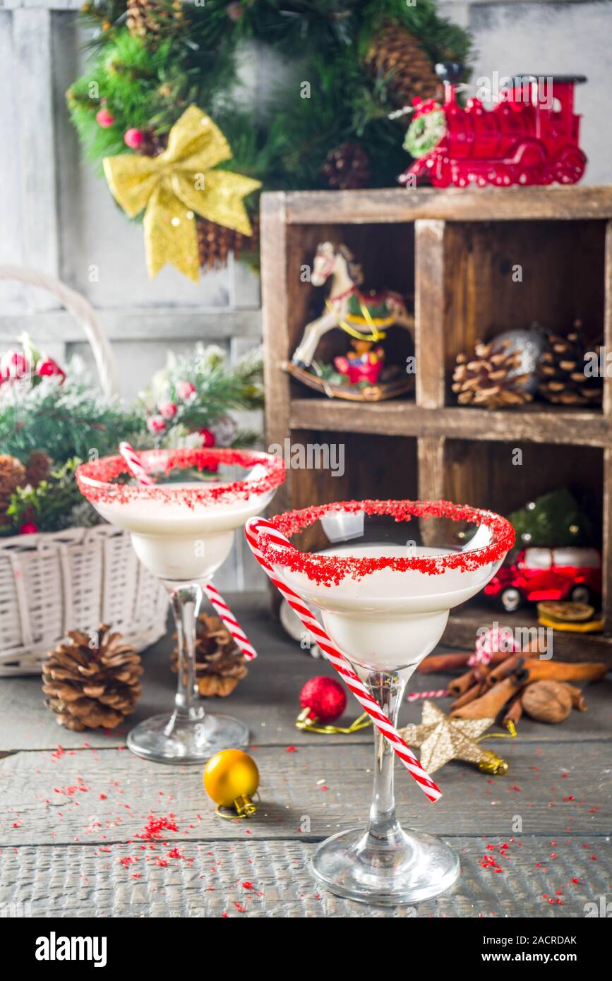 Weihnachten cocktail Rezept. Winter Alkohol trinken, White Christmas martini oder Daiquiri, auf hölzernen Hintergrund mit Weihnachten Dekoration und Pfefferminze cand. Stockfoto