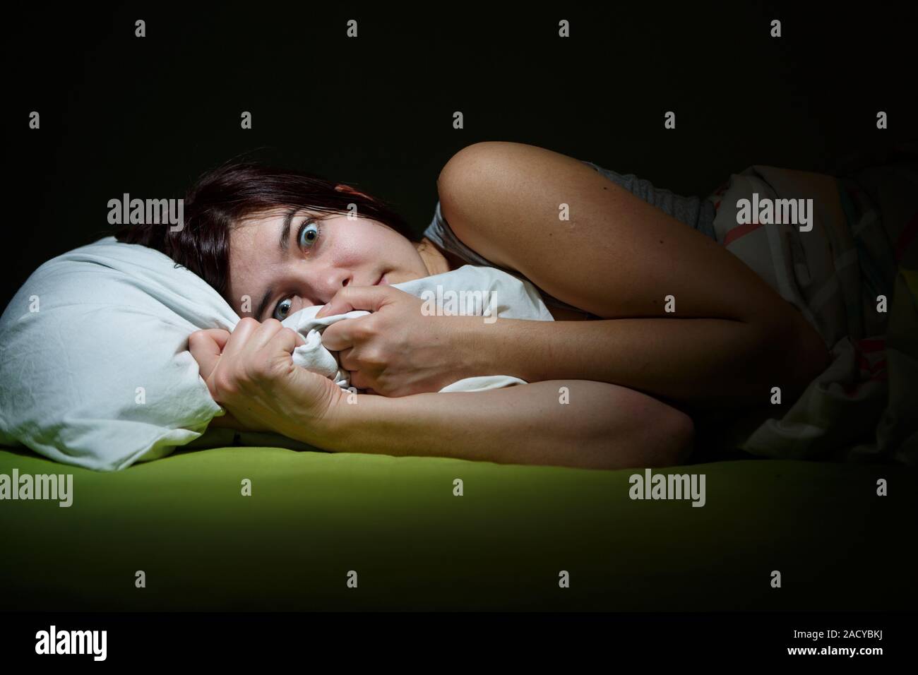 Junge Frau im Bett mit Augen geöffnet Schlaflosigkeit leiden. Konzept und Alptraum Probleme schlafen Stockfoto