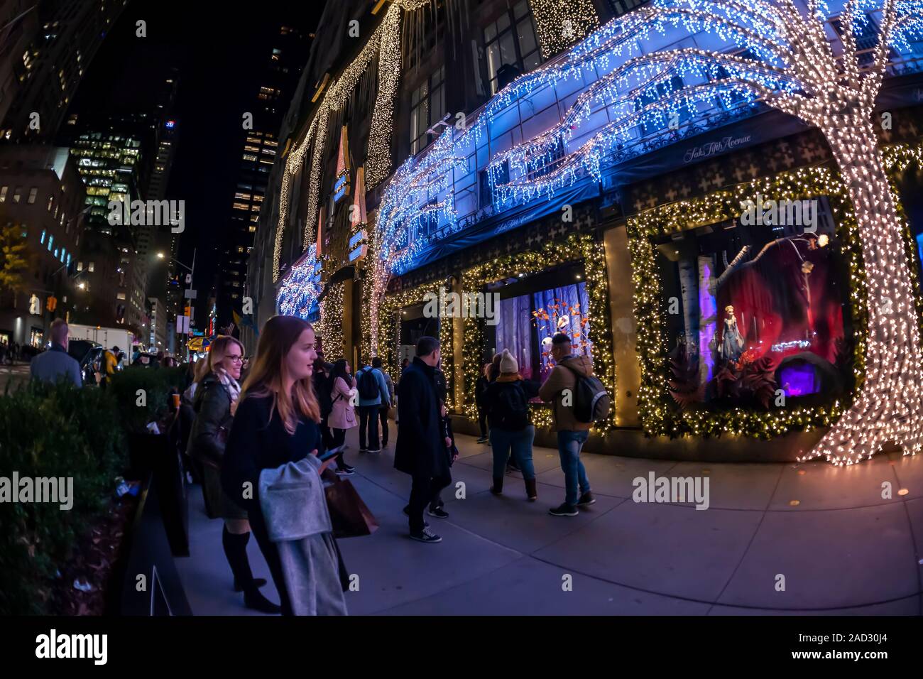 Käufer an der Weihnachten windows von Saks Fifth Avenue an der Fifth Avenue in Midtown Manhattan in New York am Dienstag, 26. November 2019. Dieses Jahr Saks Fifth Avenue hat mit Disney für "Frozen 2 "themed Windows eingegangen. (© Richard B. Levine) Stockfoto