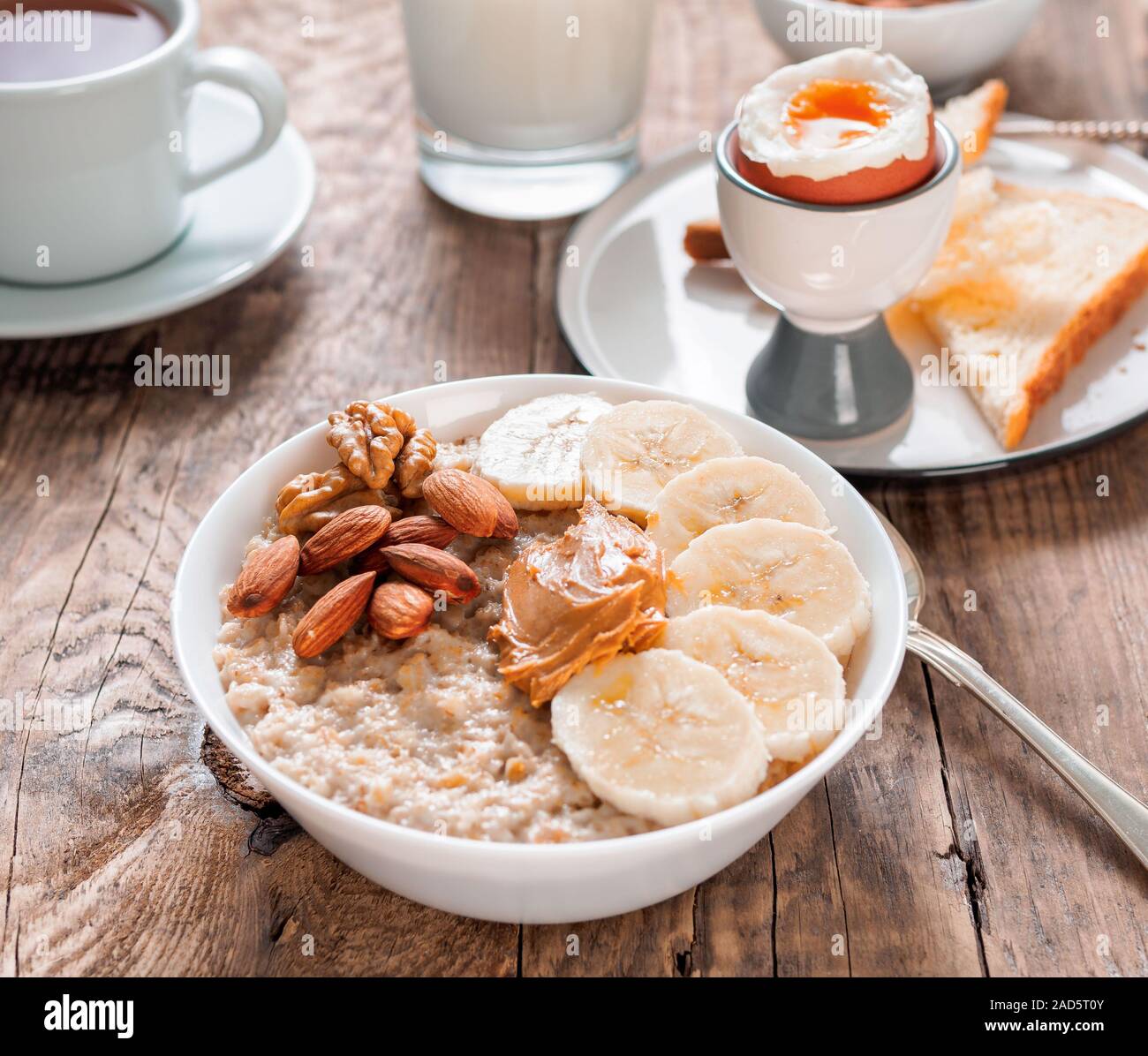 Gesundes Frühstück mit Müsli und Eier, morgen Tageslicht, rustikalen Holztisch, Seitenansicht. Stockfoto