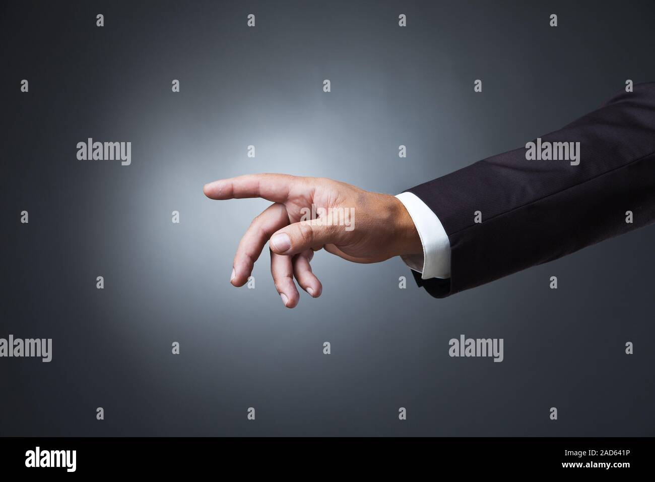 Hand poiting Symbol auf dunklem Hintergrund Stockfoto