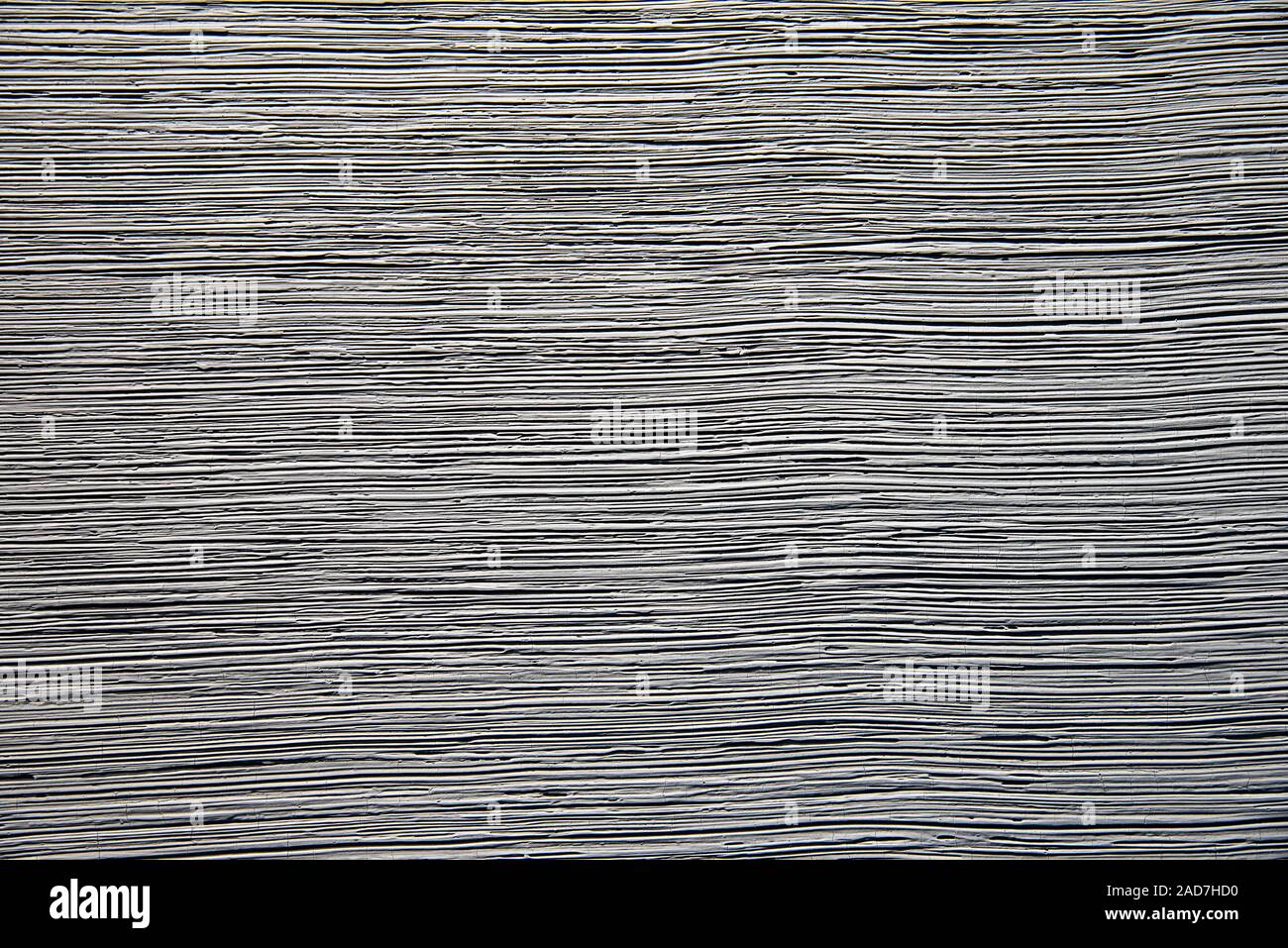 Rauher grauer Hintergrund mit einer horizontalen Textur Stockfoto