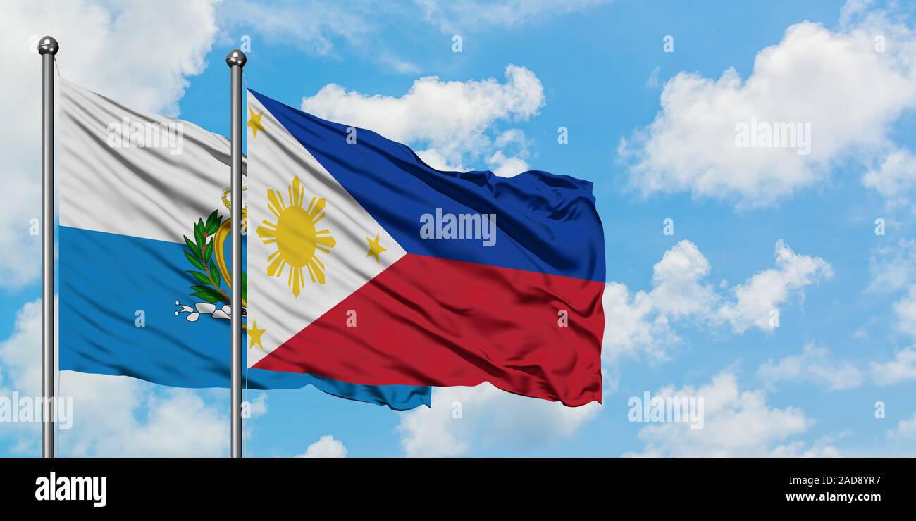 San Marino und Flagge Philippinen winken im Wind gegen Weiße bewölkt blauer Himmel zusammen. Diplomatie Konzept, internationale Beziehungen. Stockfoto
