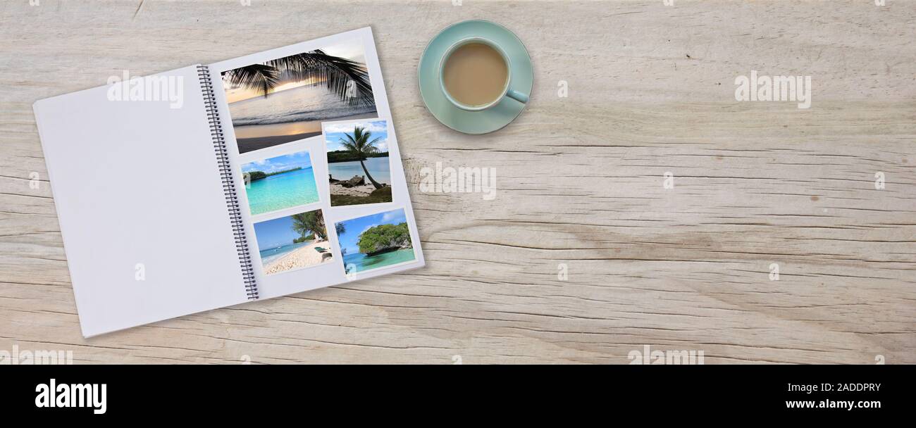 Fotobuch Album auf Deck Tisch mit Reisen Fotos von Stränden und Kaffee oder Tee in Tasse Breite Fahne Stockfoto