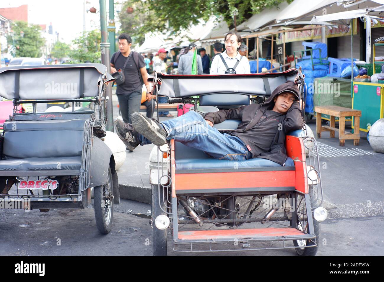 Schlafen rickshawman sieht so müde nach der Arbeit und immer mehr Passagiere in der Nacht. Er braucht mehr Geld für die Familie zu Hause zu unterstützen. Stockfoto