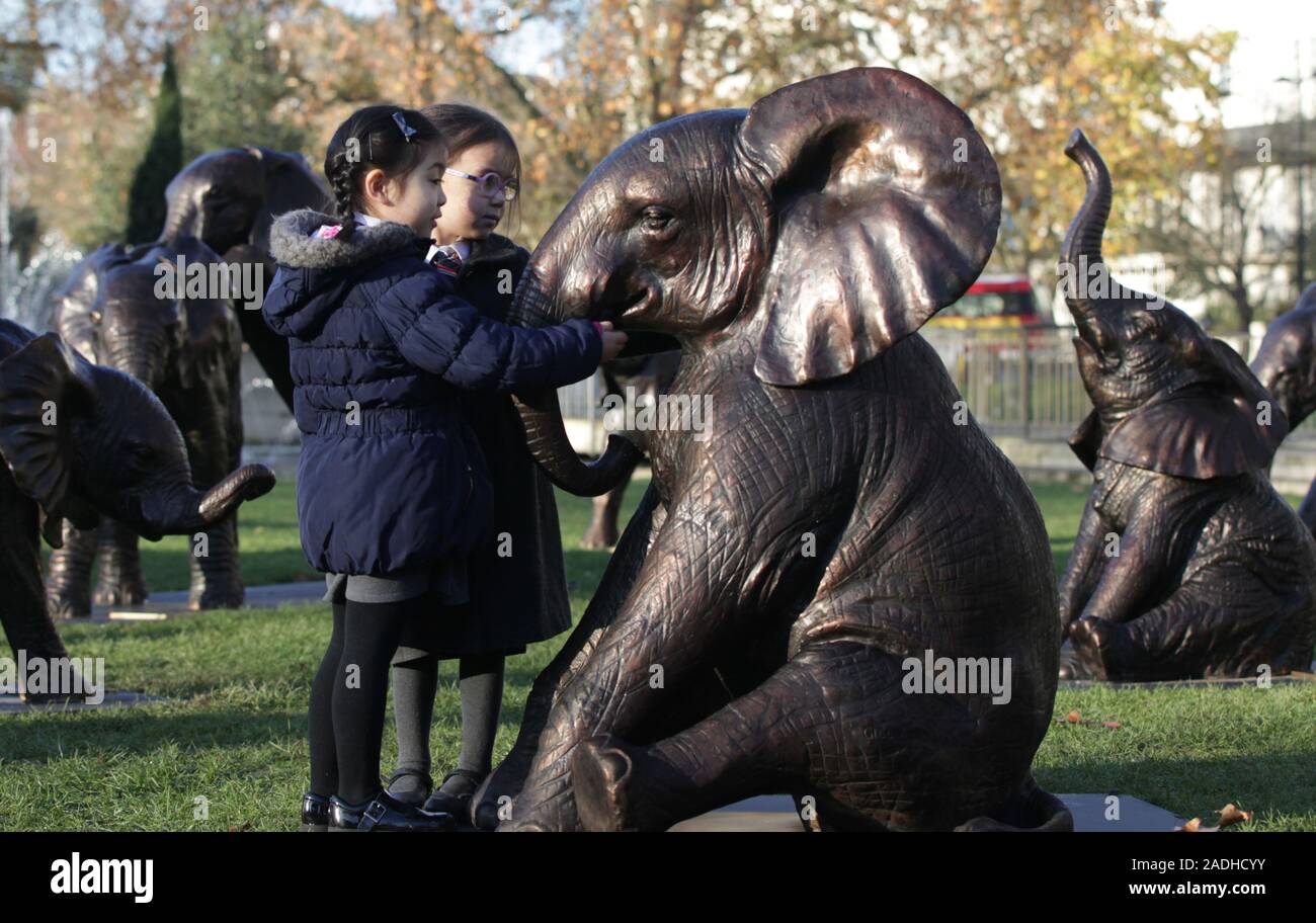 Rosalind Cheung, fünf, (rechts) und Georgie Chubb, vier, von Hampden Gurney Primary School in London, stand neben einem der 21 Bronze lebensgroße Elefanten am Marble Arch Inn, London vorgestellt, die Notlage der Arten, die vom Aussterben bedroht Gesicht 2040 zu markieren. Stockfoto