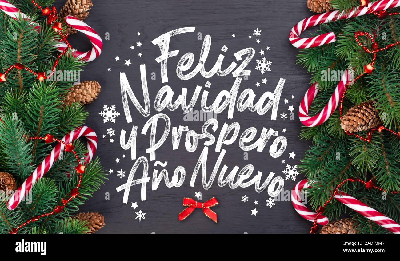 Weihnachtskarte mit wünschen Worte auf Spanisch "frohe Weihnachten und ein glückliches neues Jahr!" (Feliz Navidad y Prospero año Nuevo). Christmas tree branch Decora Stockfoto