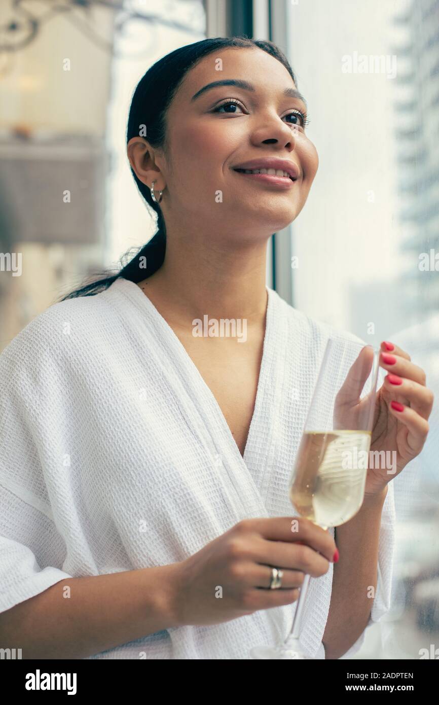 Schöne entspannte Frau mit Champagner lächelnd Stockfoto