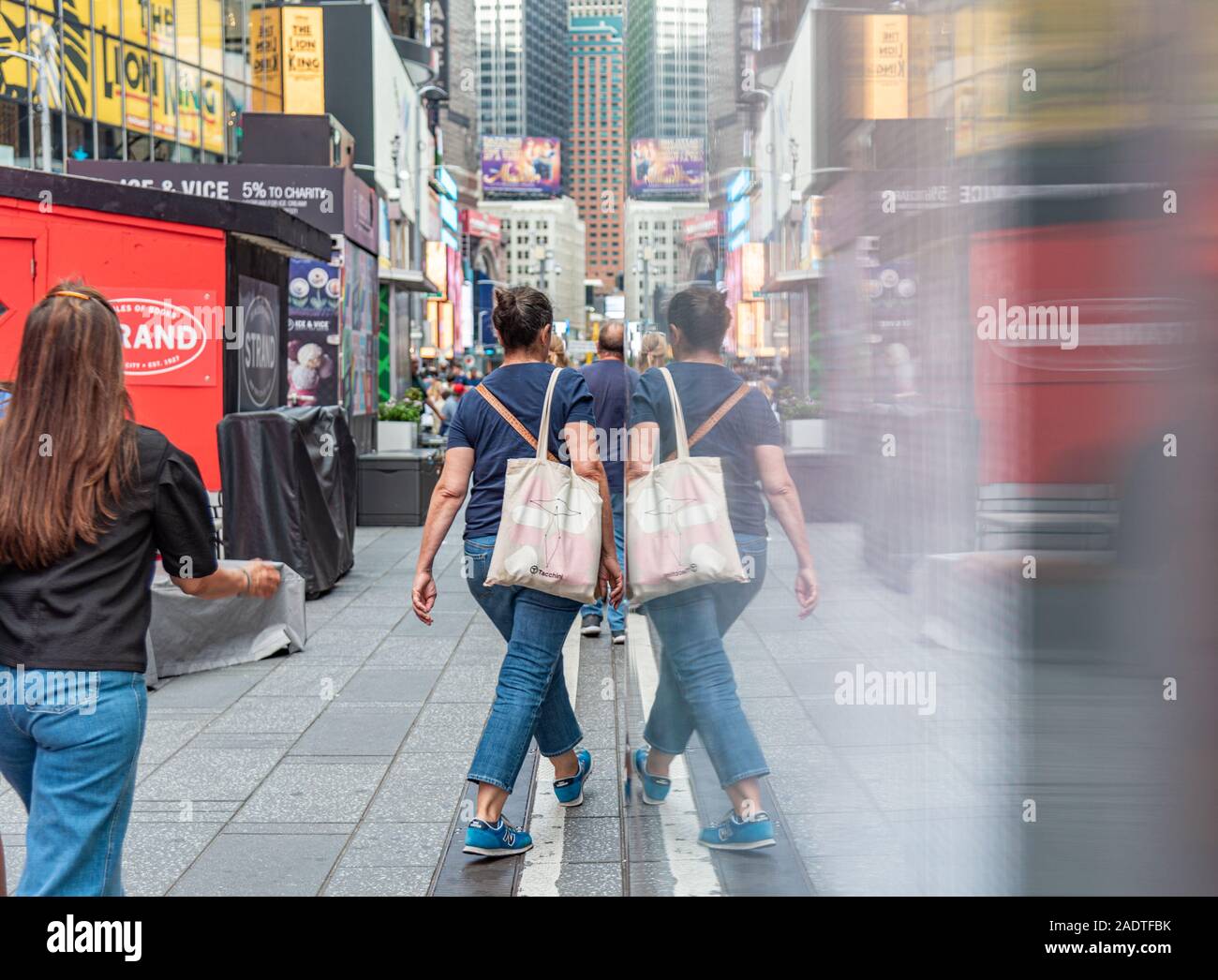 Manhattan New York Farbe Bild Spiegel bild - Spiegelbild der Menschen in Time Square Stockfoto