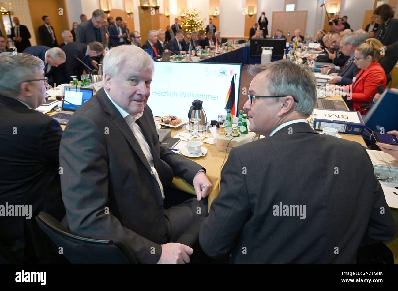 06 Dezember 2019, Schleswig-Holstein, Lübeck: Horst Seehofer (CSU), Bundesminister des Innern, sitzt zwischen Staatssekretär Hans-Georg Engelke (r) und Lorenz Caffier (CDU), Innenminister von Mecklenburg-Vorpommern, in der Sitzung der CDU/CSU-geführten Staaten im Rahmen der Konferenz der Innenminister. Die Länder hatten angekündigt, dass sie Themen wie die Bekämpfung von Rechtsextremismus und Antisemitismus, Umgang mit Hassreden auf dem Internet und die Einwanderungs- und Flüchtlingspolitik besprechen würden. Foto: Carsten Rehder/dpa Stockfoto