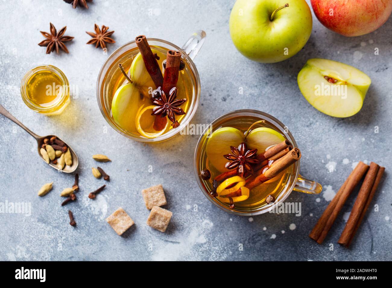 Apple Glühwein Apfelwein mit Gewürzen in Glas Schale. Grauen Stein Hintergrund. Ansicht von oben. Stockfoto