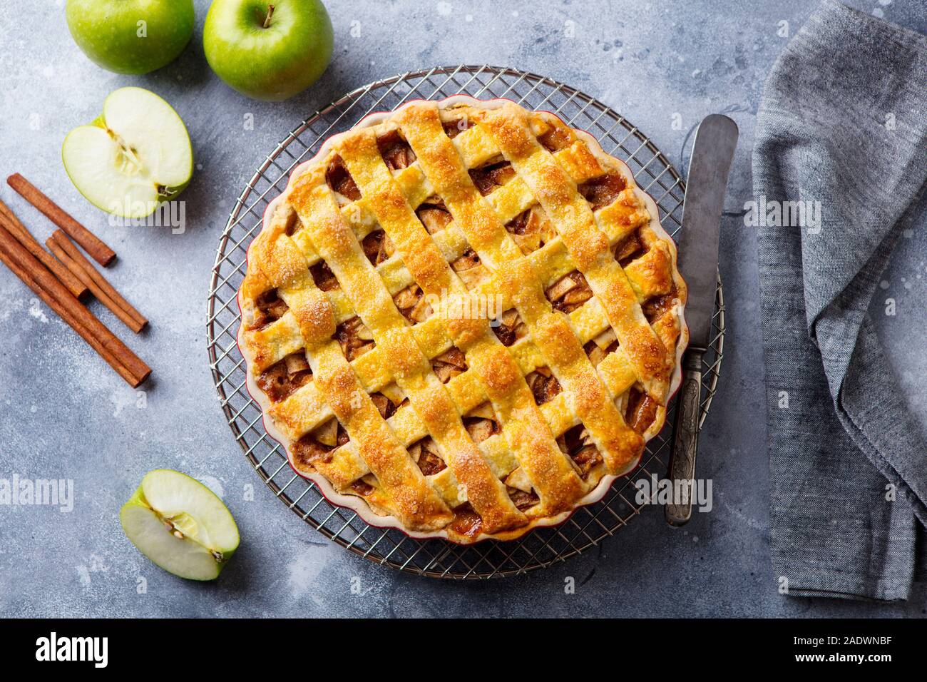 Apfelkuchen mit Karamell auf ein Gitter. Grauer Hintergrund. Ansicht von oben Stockfoto