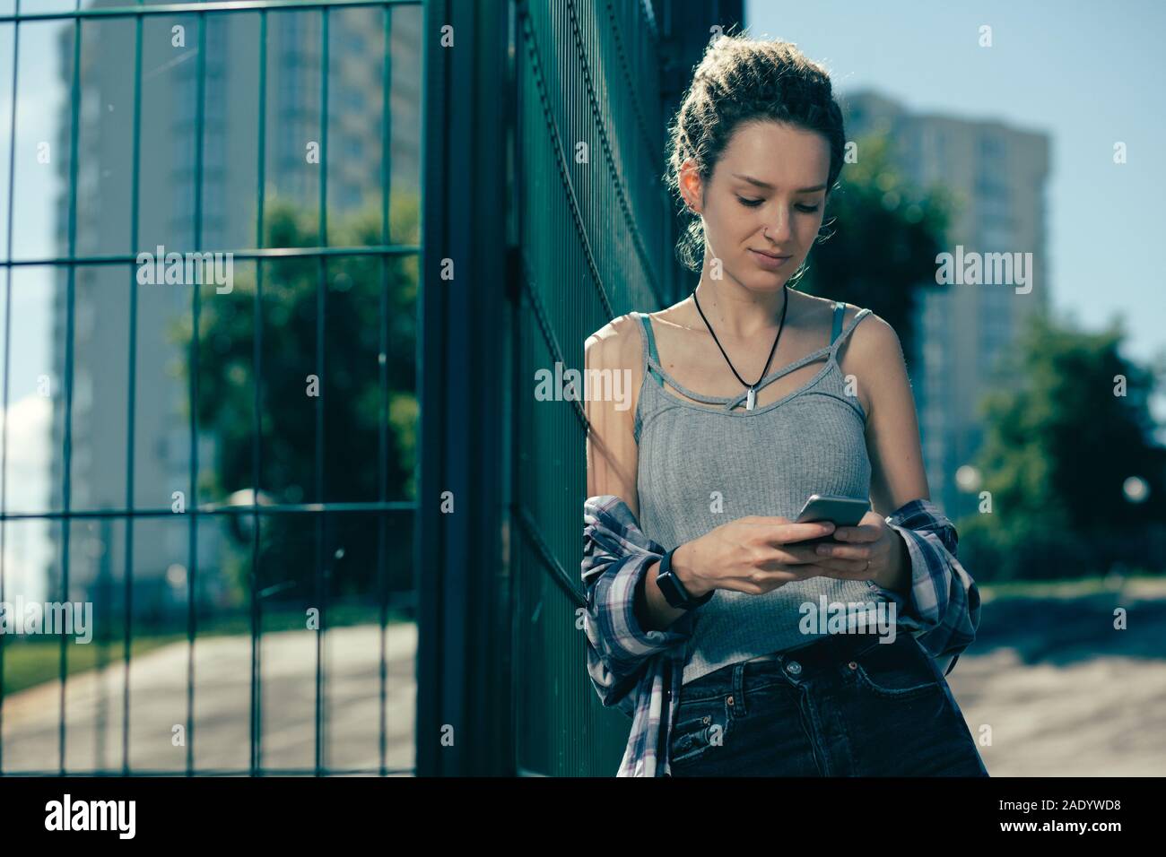 Nachdenklich Dame an den Bildschirm Ihres Smartphones, während draußen sein Stockfoto