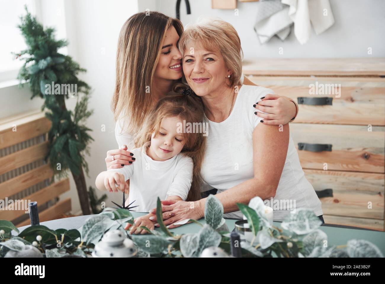 Cute Umarmungen. Mutter, Großmutter und Tochter eine gute Zeit in der Küche Stockfoto