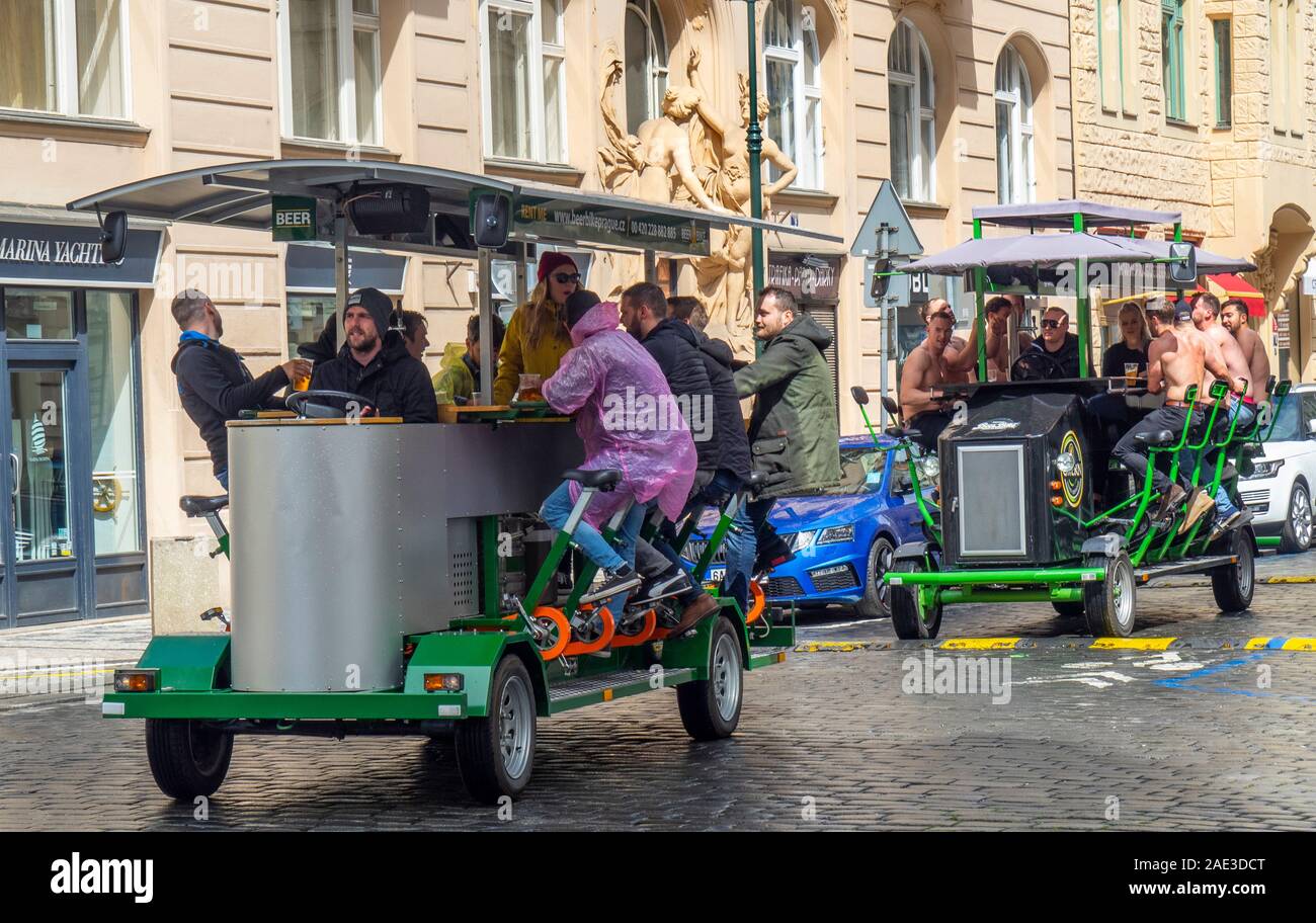 Männliche Touristen eine Party trinken Ale oder Bier auf ein Bier Bike durch die Straßen von Prag in der Tschechischen Republik. Stockfoto