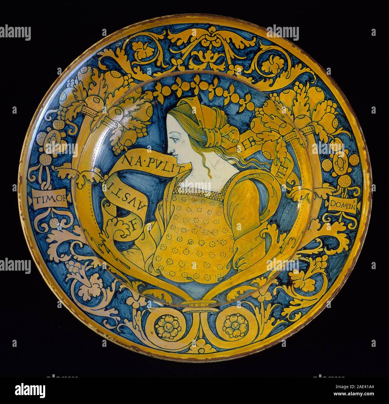 Eine große Schale aus hautglasiertem Steingut (Maiolica) aus dem 16. Jahrhundert mit einer zentralen Profilbüste von Faustina mit einem Rand aus floralen Scrollarbeiten und Kornukopien, die italienische Renaissance-Keramikdekoration zeigen. Stockfoto
