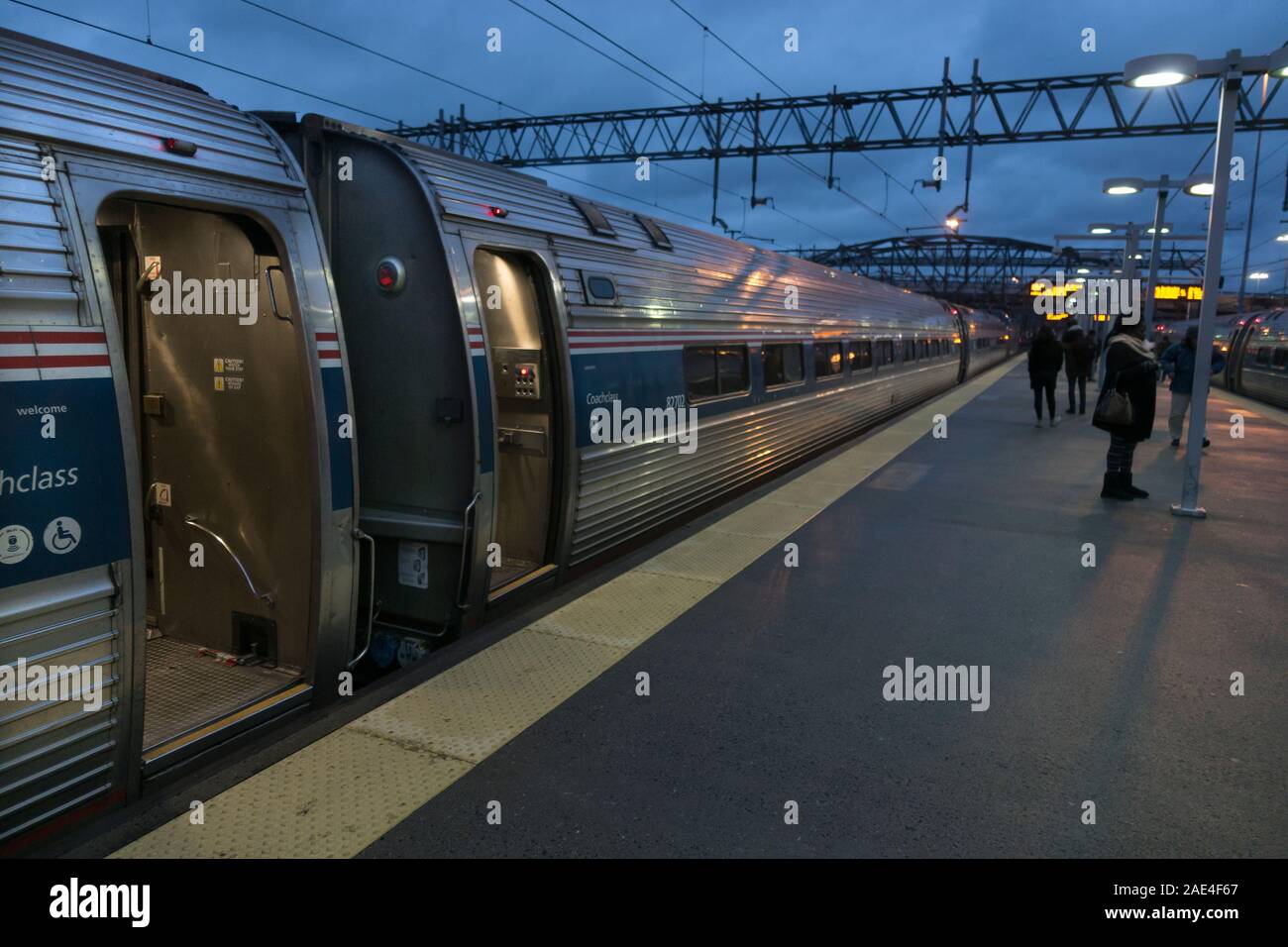 Amtrak Northeast regional Bahn erwartet Abfahrt und Passagiere außerhalb New Haven Station in der Abenddämmerung. Stockfoto