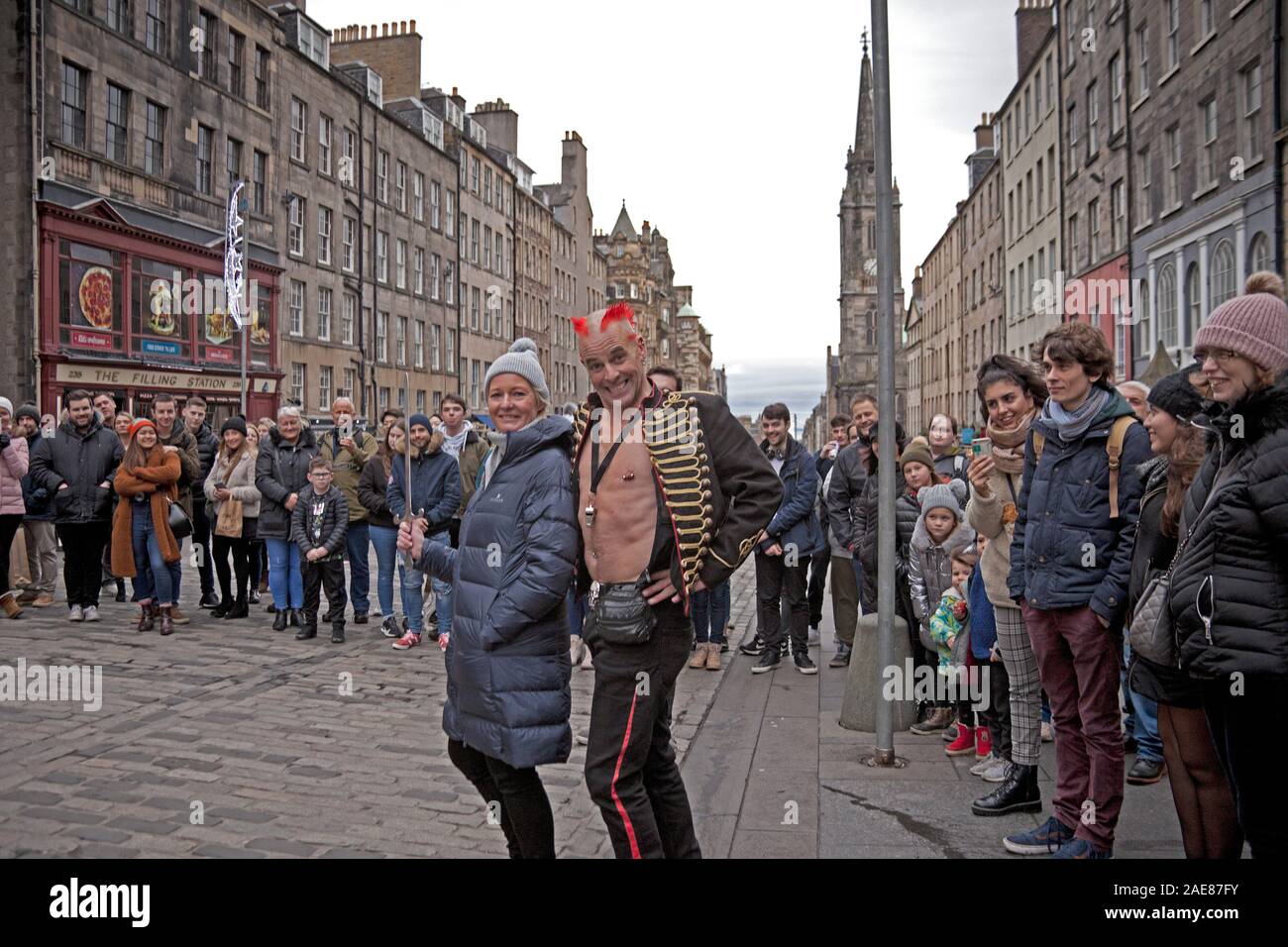 Edinburgh, Schottland, UK, 7. Dezember 2019. Die bunten Mächtigen Gareth Street Performer aus London angereist, um seine Show auf der Royal Mile, um Touristen und Käufer, die durch die High Street entfernt wurden, bevor der Regen begann, war kurz nach 2 Uhr und getränkt Käufer auf einem trostlosen Princes Street zu unterhalten. Stockfoto