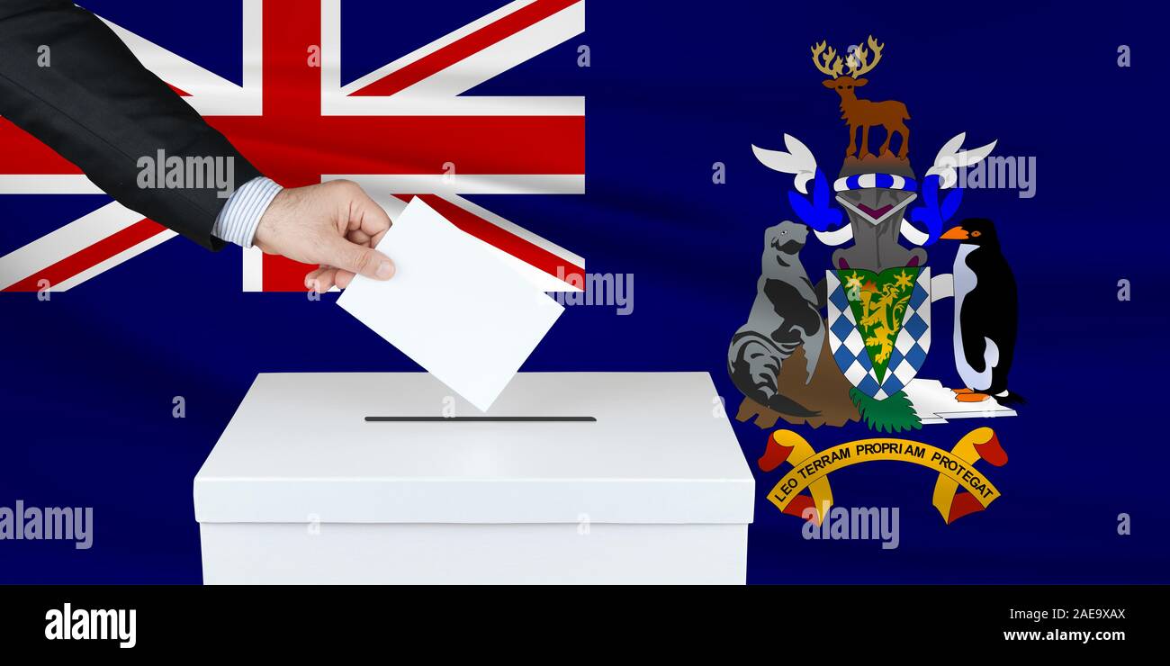 Wahl in Südgeorgien. Die Hand des Menschen, der seine Stimme in die Wahlurne setzt. Winkte Südgeorgien Flagge auf Hintergrund. Stockfoto