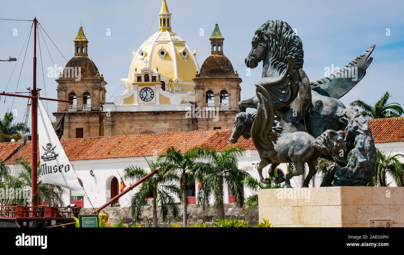 Detailansicht des Pegasus statue am Wharf in Cartagena mit Kirche des Hl. Petrus Claver (Iglesia de San Pedro Claver) als Hintergrund Stockfoto