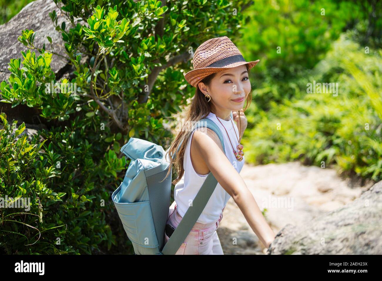 Japanische Frau mit Hut und mit Rucksack auf einer Wanderung. Stockfoto