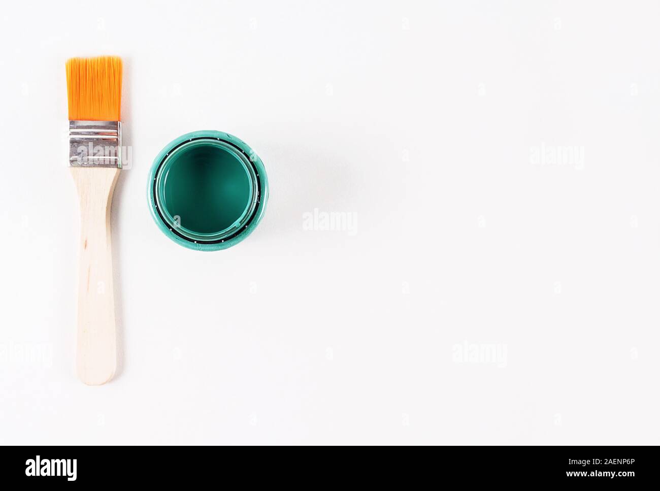 Blick von oben auf die kleine Bürste mit Holzgriff und grünen Aquarellfarbe in neu eröffneten können Blechdose auf hellen Hintergrund. Kopieren Sie Platz. Minimalismus lifestyl Stockfoto