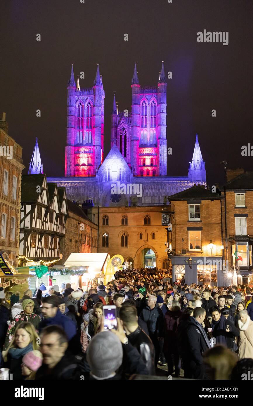 Die Kathedrale von Lincoln Flutlicht mit farbigem Licht im Jahr 2019 eingeführt. Bild während der Weihnachtsmarkt auf Schloss genommen. Stockfoto