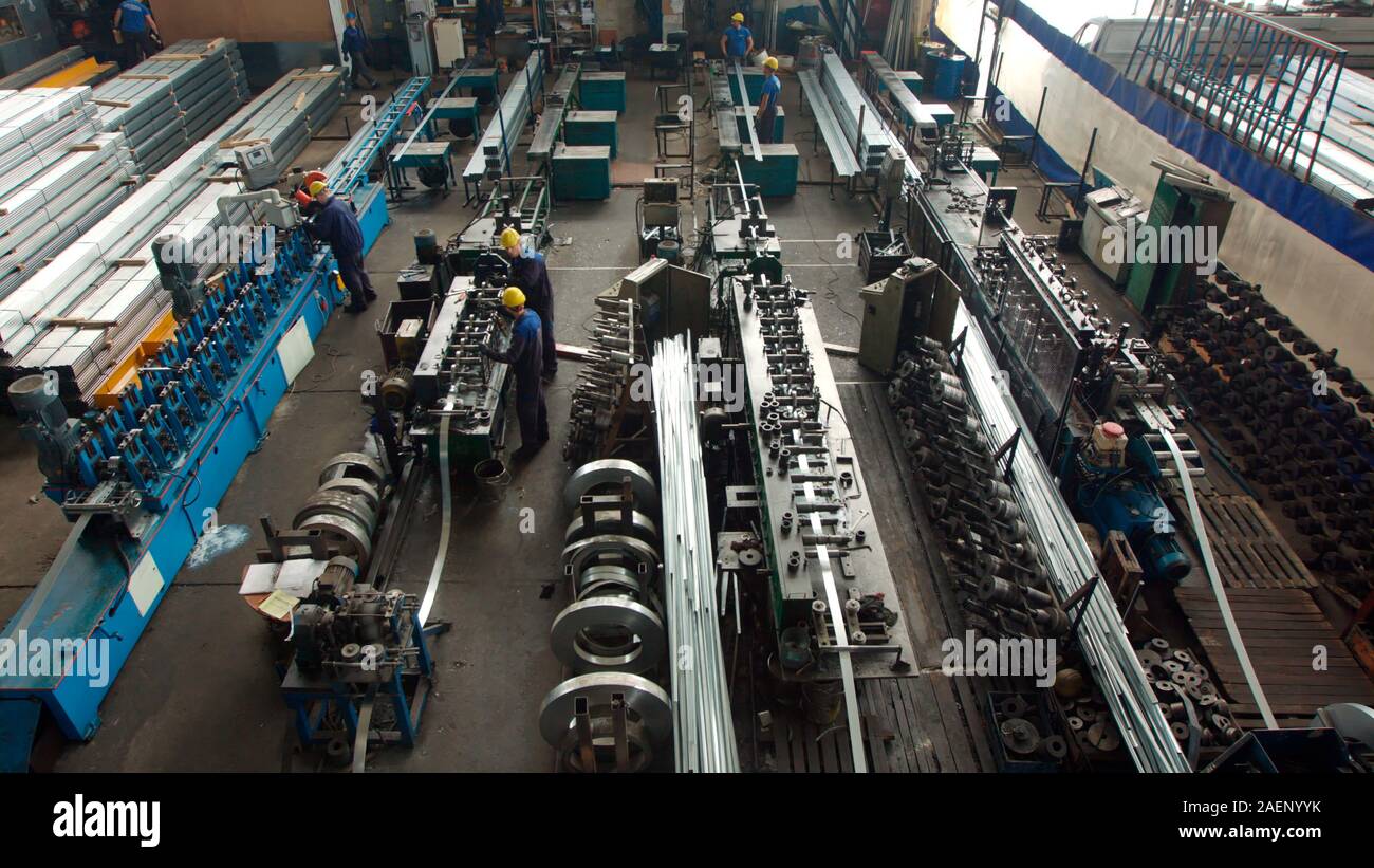 Innenraum der Produktion in der modernen Anlage zu einem schweren industriellen Fabrik. Mitarbeiter in Helm Betrieb eines Metall verarbeitenden Maschinen, Manu Stockfoto