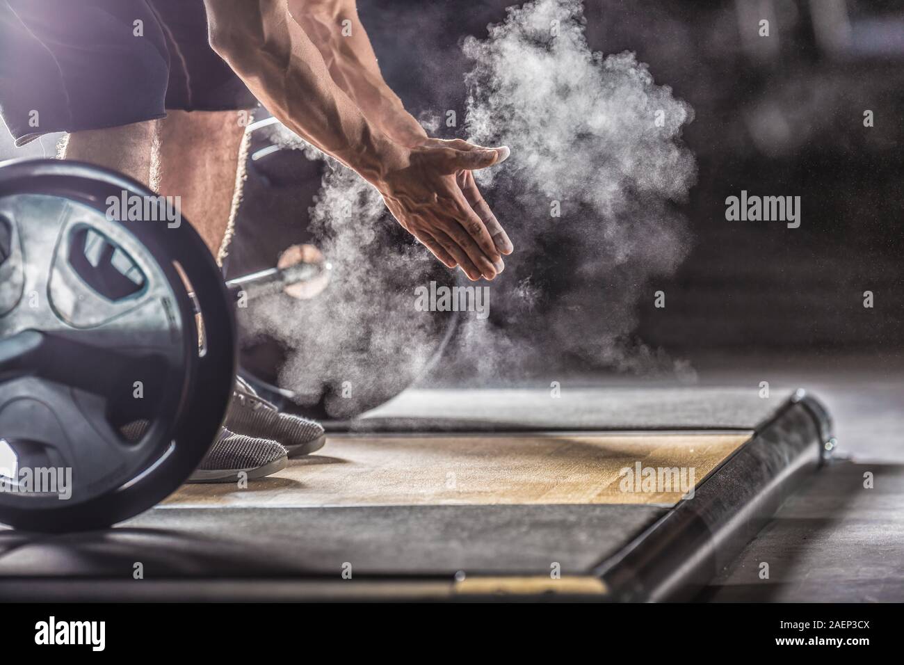 Muskulöse Gewichtheber Klatschen der Hände vor dem langhantel Workout im Fitnessraum mit Hanteln. Stockfoto