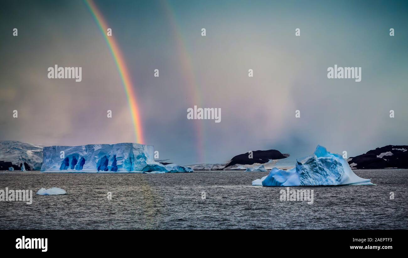 Ein Regenbogen und Sturm mit Eisbergen in der Admiralty Bay, Antarktis ...