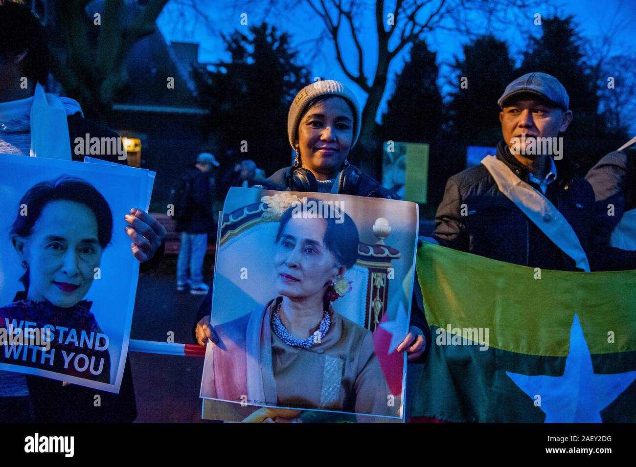 Unterstützer von Aung San Suu Kyi halten Plakate außerhalb der Internationale Gerichtshof Gebäude während der Demonstration. Aung San Suu Kyi ist geplant, eine Delegation zu führen der Internationale Gerichtshof (IGH) Myanmar gegen den Vorwurf des Völkermords für zwei Tage zu verteidigen. Außerhalb des IGH Gebäude Spannung war hoch, da Hunderte von Anhängern von Aung San Suu Kyi aus verschiedenen Ländern versammelt zu empfangen und ihre Unterstützung für die myanma Zustand Ratgeber zeigen. Aber auch Hunderte von Menschen aus der Europäischen Rohingya Council (ERC) und Myanmar Muslim Association Niederlande (MMAN) Orgel Stockfoto