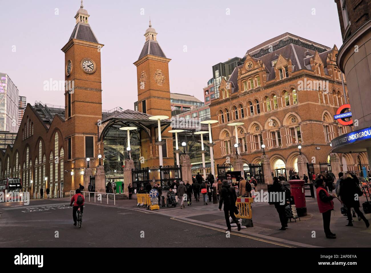 Die Menschen verlassen die Arbeit zu Fuß auf der Straße außerhalb der Liverpool Street Station Eingang an einem Winterabend ein Zug home London UK KATHY DEWITT zu fangen Stockfoto