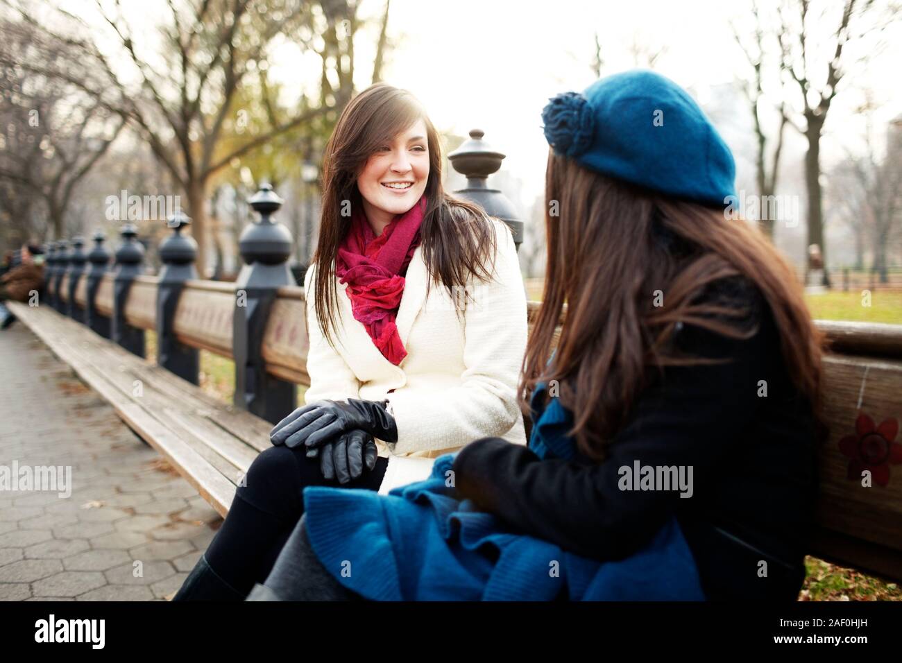 Freunde sitzt auf der Bank im Stadtpark im Winter Stockfoto