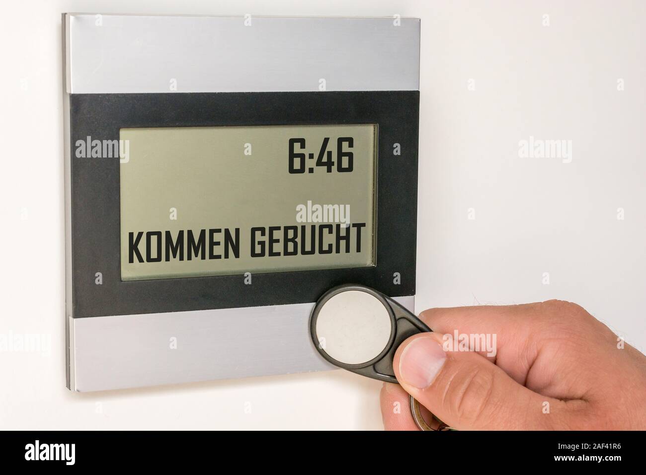 Moderne Weltzeituhr mit Zeiterfassung durch einen Chip mit dem Text in der deutschen Sprache 'kommen' gebucht. Stockfoto