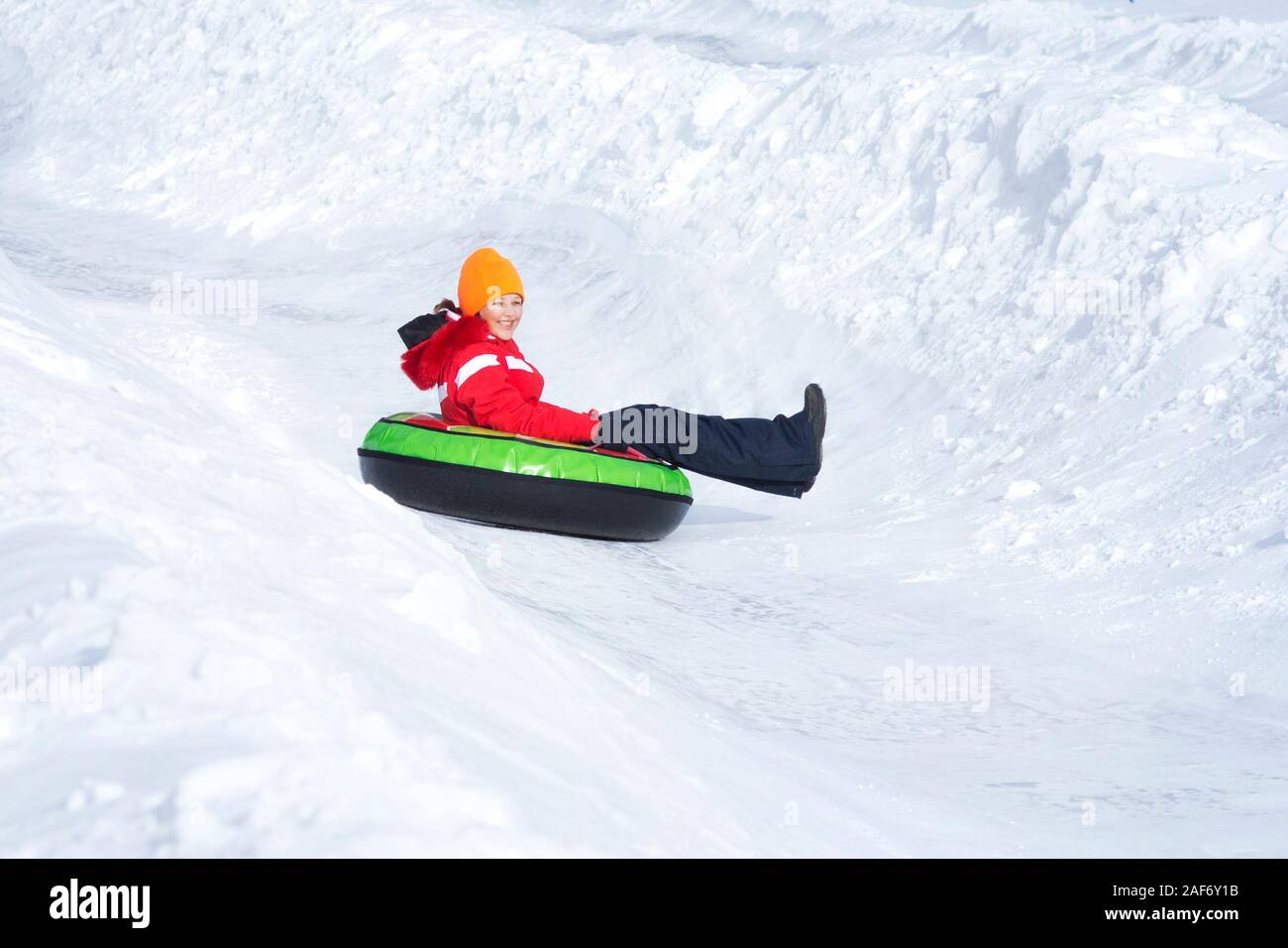 Kind, Mädchen auf Schnee Rohre Downhill im Winter Tag. Stockfoto