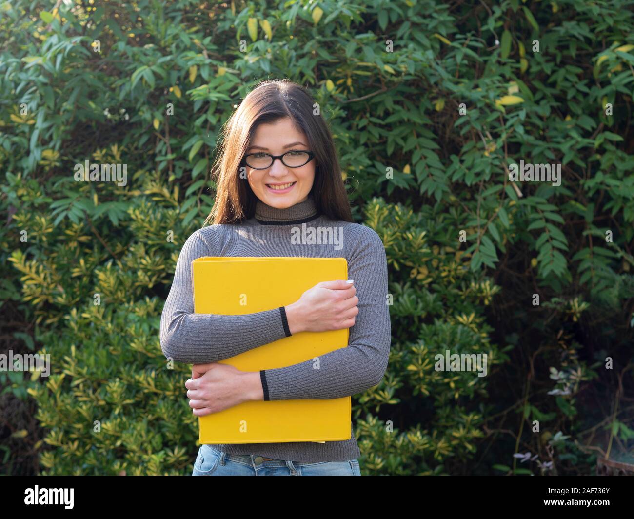 Mädchen Student an der Kamera schaut im Sonnenschein Stockfoto