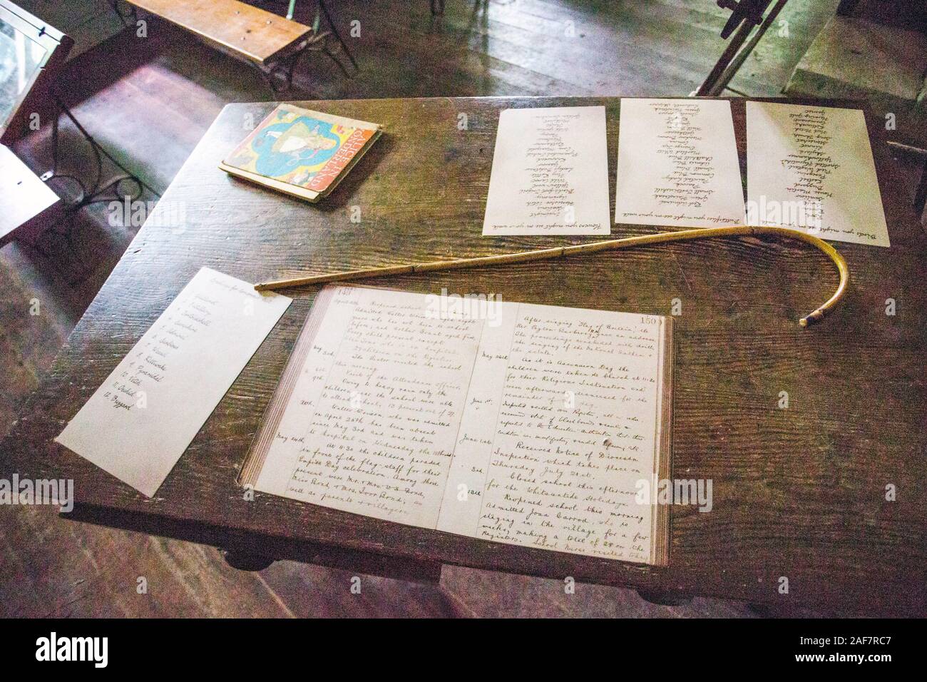 Die schulzimmer innen Lehrer hat noch den offenen Schule Tagebuch und Zuckerrohr in das verlassene Dorf Tyneham, Dorset, England, Großbritannien Stockfoto