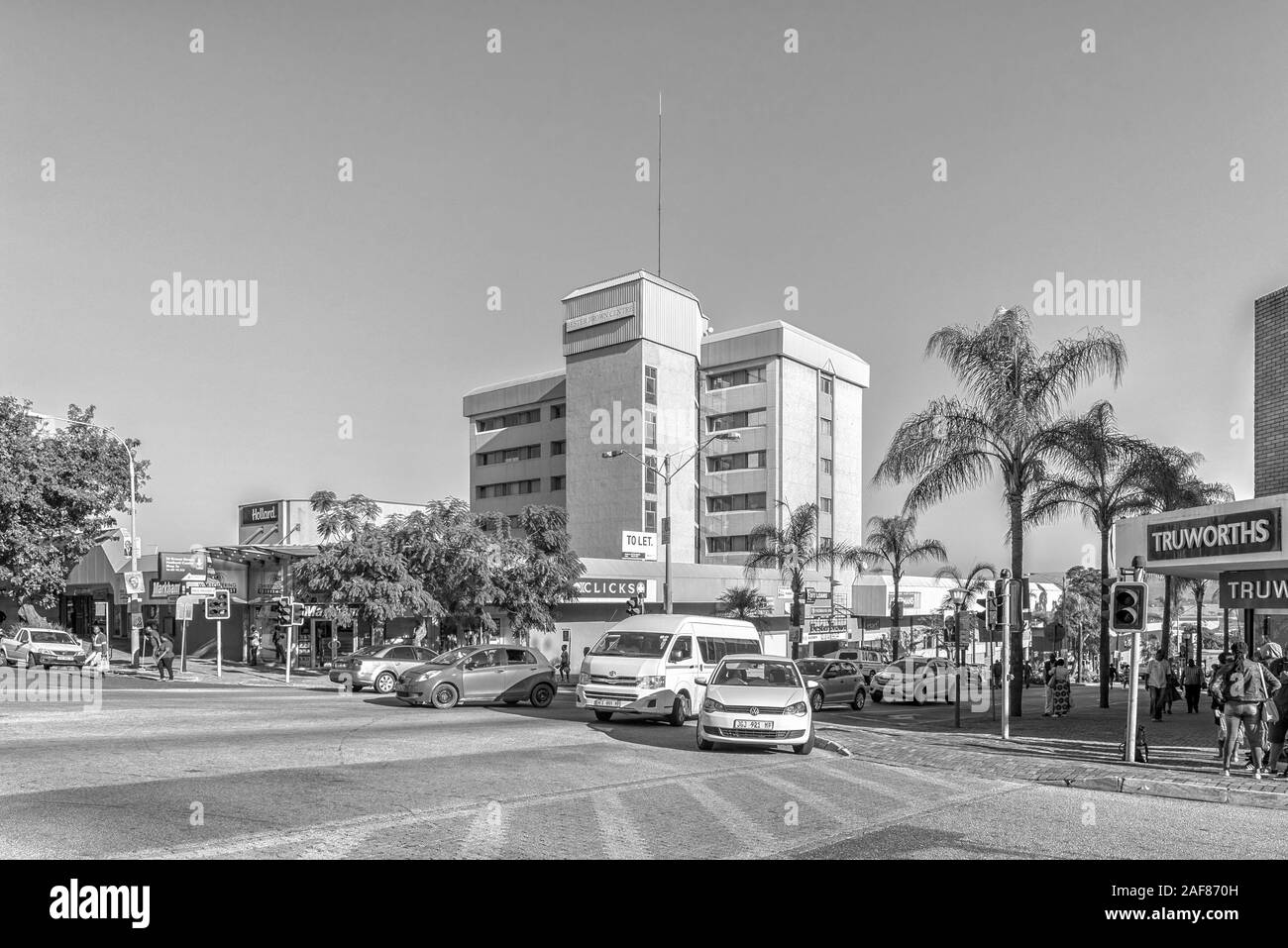 NELSPRUIT, SÜDAFRIKA - Mai 3, 2019: eine Straße, Szene, mit Unternehmen, Personen und Fahrzeuge, in Nelspruit, in der Provinz Mpumalanga. Schwarzweiß Stockfoto