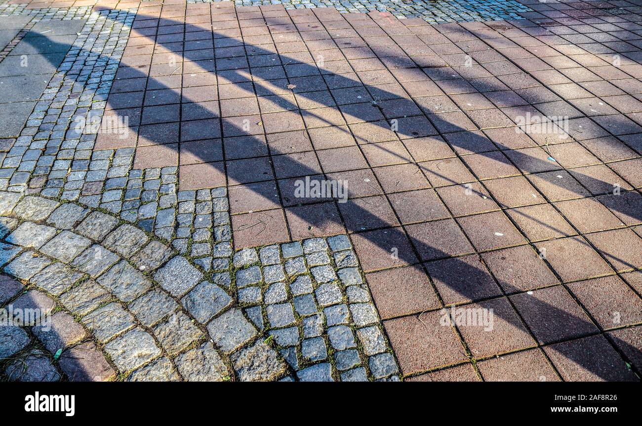 Die Schatten von Menschen in einem Einkaufszentrum auf einer gepflasterten Boden Stockfoto