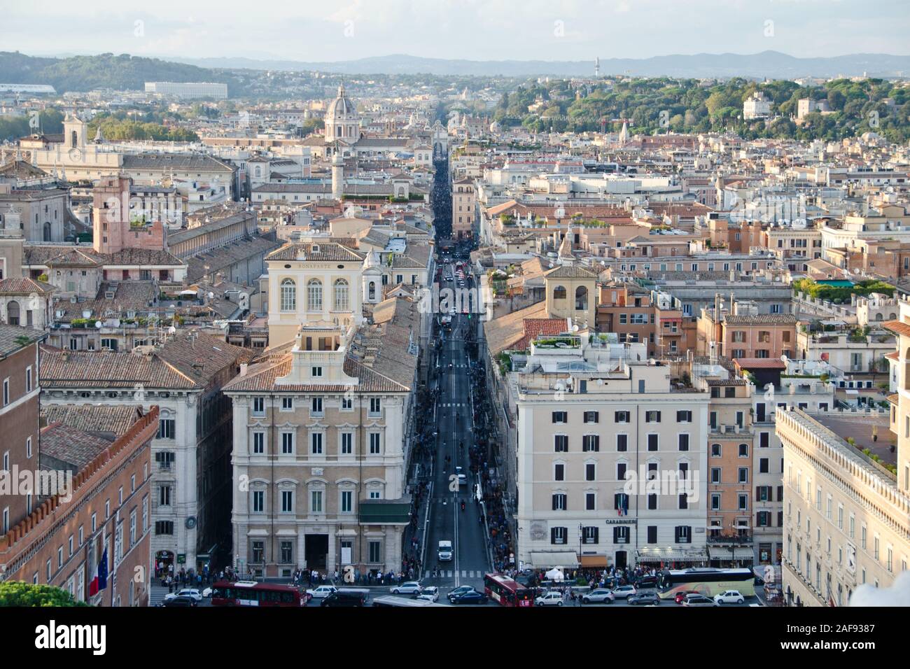 Bild an einem sonnigen Tag vom Fuß der piazza di Spagna im Zentrum von Rom, der langen Straße Via del Corso, mit allen wichtigen Geschäften. Stockfoto
