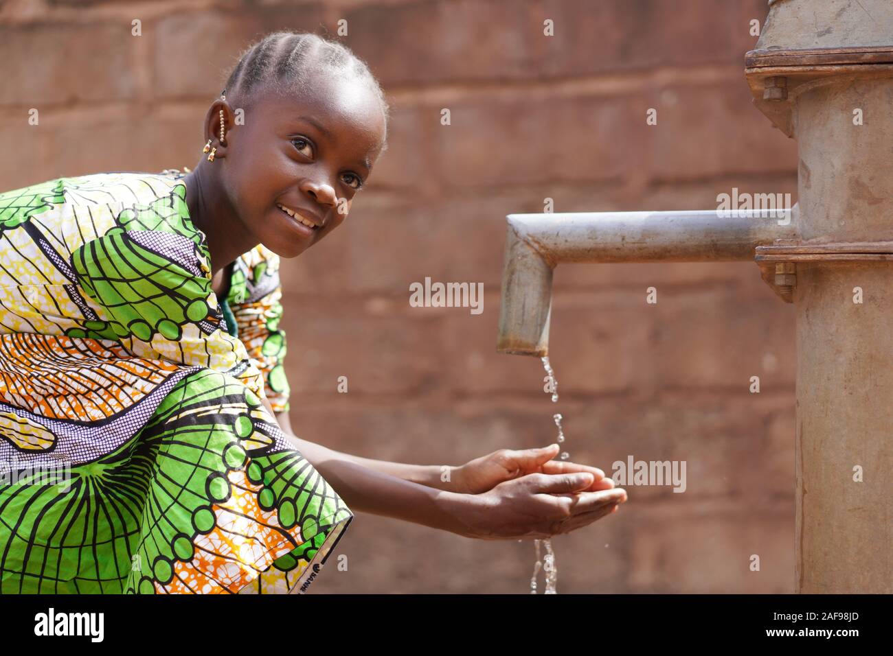 Wasser-Symbol für afrikanisches Schwarzgirl Kid Kinderwäsche und -Trinken Stockfoto