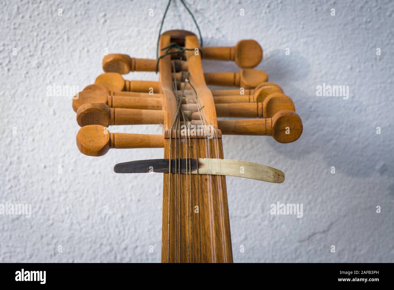 Spindelstock mit Abholung, Plektrum aus Horn, auf Strings einer alten arabischen Oud Instrument. Stockfoto