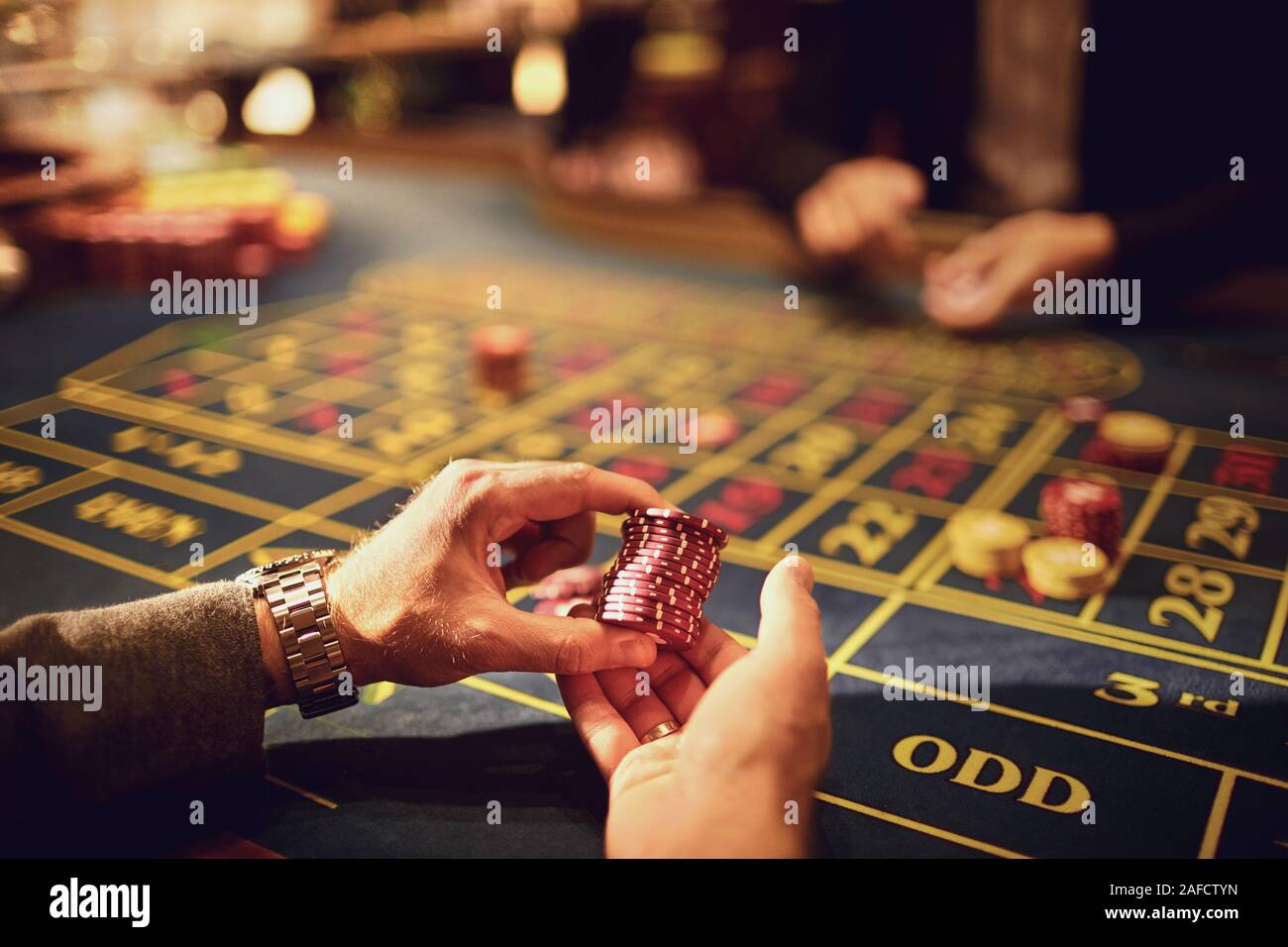 Chips in den Händen der Spieler in einem Casino. Stockfoto