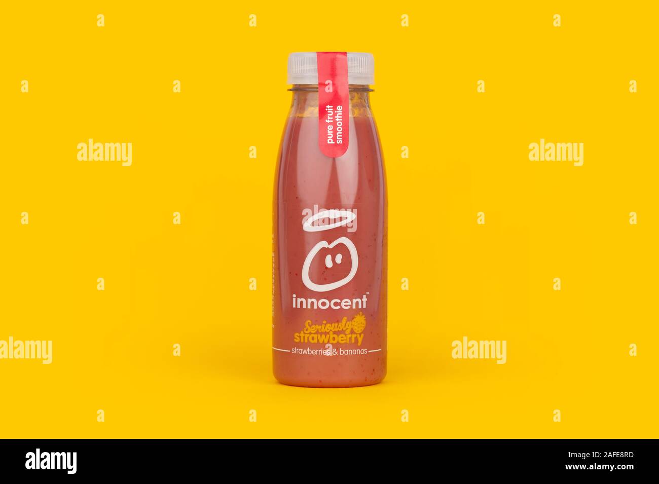 Eine Flasche unschuldige Ernst Erdbeere Smoothie trinken Schuß auf einen gelben Hintergrund. Stockfoto