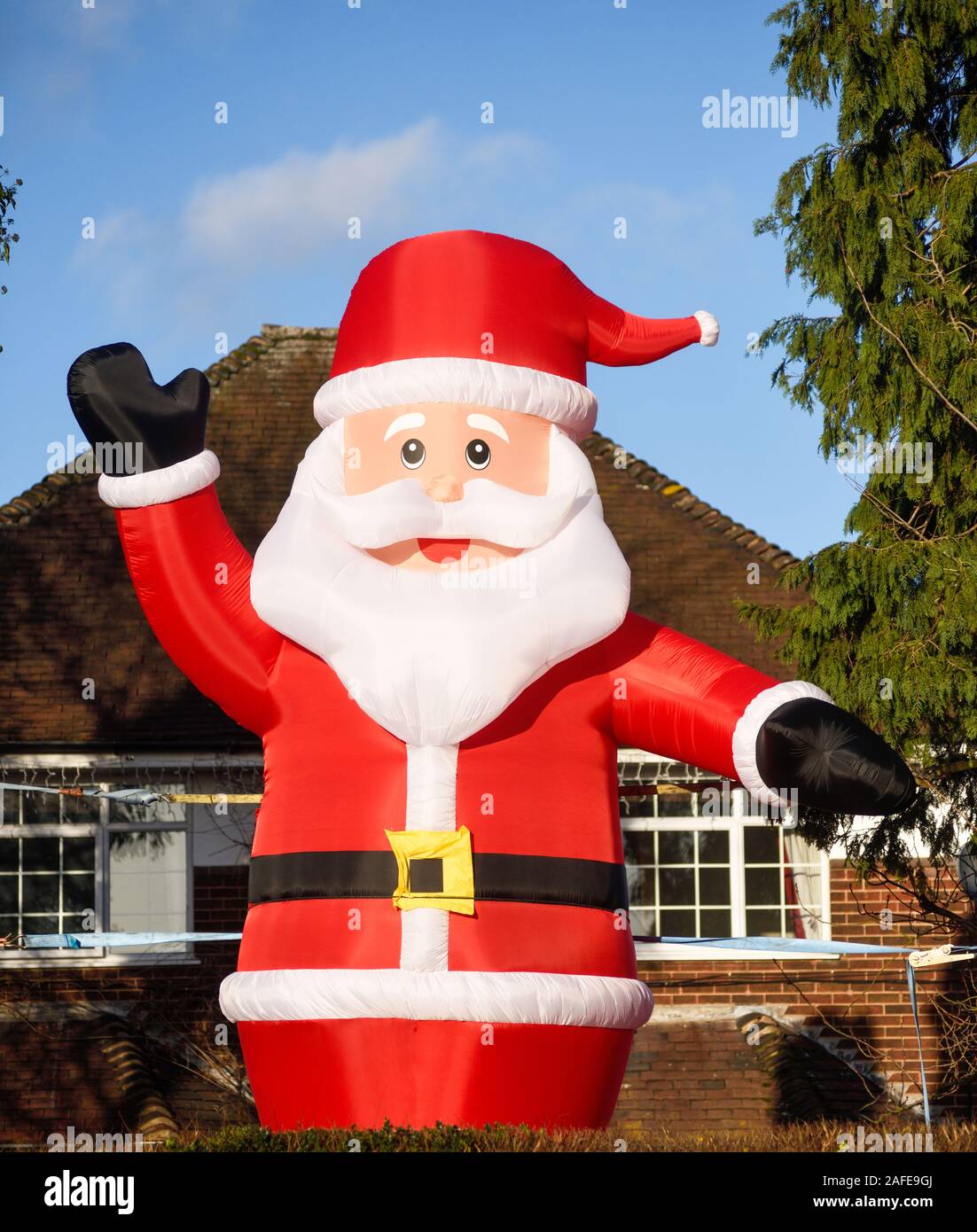 Riesigen aufblasbaren Weihnachtsmann winkt von Straßenkontrollen. Stockfoto