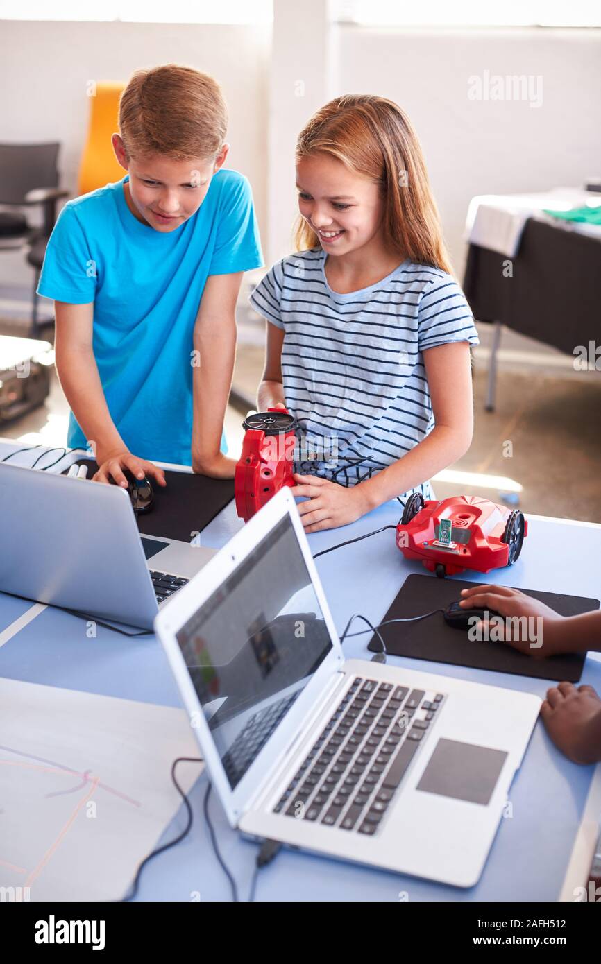 Zwei Schüler der Klasse nach der Schule Computer Coding Programmieren lernen Roboter Fahrzeug Stockfoto