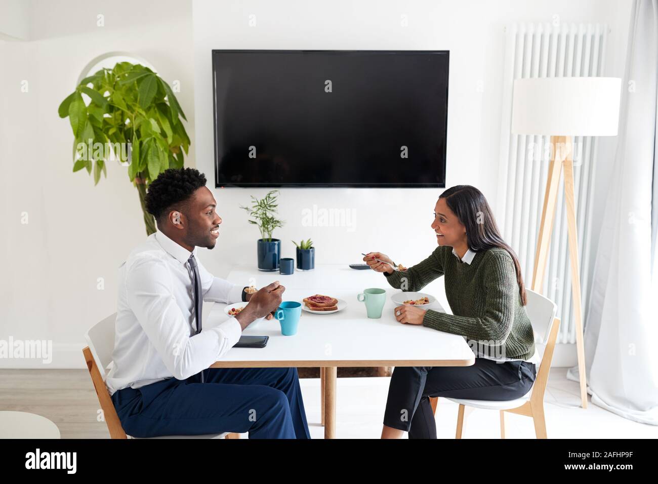 Business Paar zu Hause essen Frühstück, bevor Sie für Arbeit Stockfoto