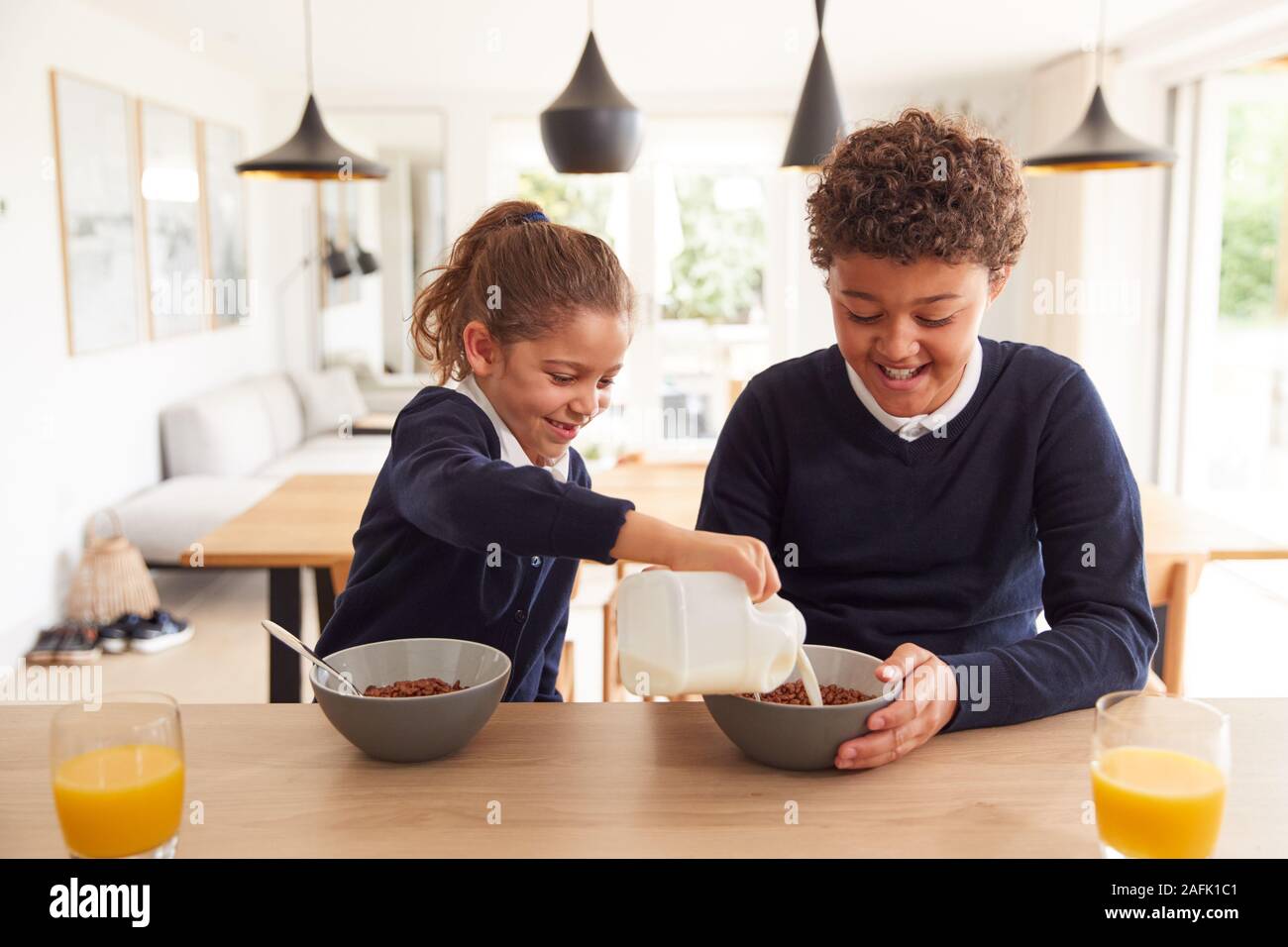 Kinder In der Küche Essen der zuckerhaltigen Frühstück, bevor Sie in die Schule gehen Stockfoto